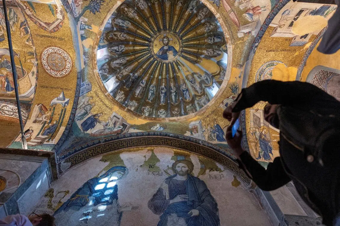 FILE PHOTO: A visitor takes a picture at Chora Museum or Kariye Mosque, one of the city's most celebrated Byzantine churches which was reconverted into a mosque in 2020 and re-opened its doors to visitors and worshippers after a four year-long restoration process, in Istanbul, Turkey, May 6, 2024. REUTERS/Umit Bektas/File Photo