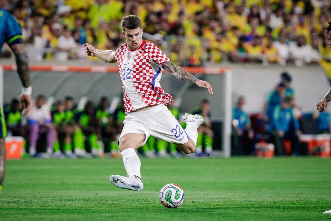 Mar 26, 2026; Orlando, Florida, USA; Croatia defender Luka Vuskovic (22) kicks the ball to score a goal against Colombia during the first half at Camping World Stadium. Mandatory Credit: Travis Register-Imagn Images