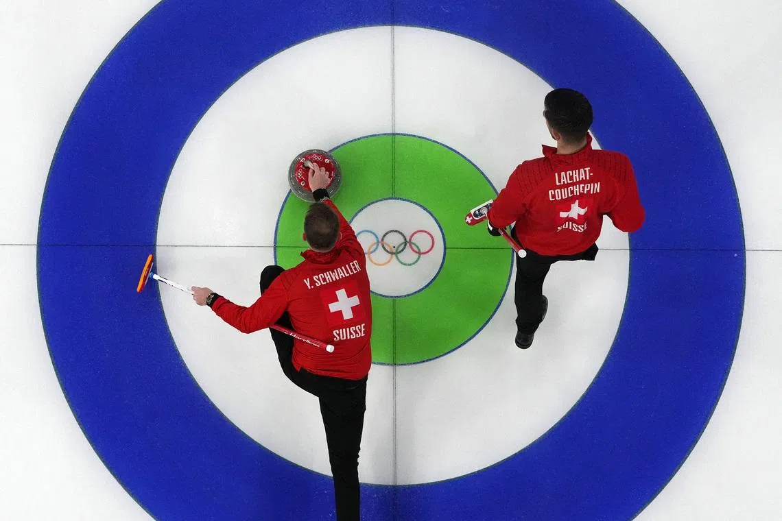 Milano Cortina 2026 Olympics - Curling - Men's Round Robin Session 9 - Switzerland vs Sweden - Cortina Curling Olympic Stadium, Cortina d'Ampezzo, Italy - February 17, 2026. Pablo Lachat-Couchepin of Switzerland and Yannick Schwaller of Switzerland in action during the match against Sweden REUTERS/Issei Kato