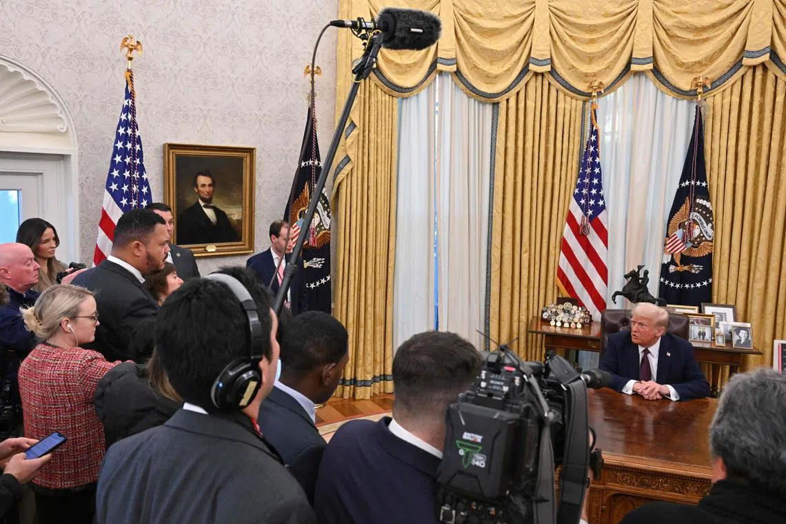 US President Donald Trump speaking to the media as he signs executive orders at the White House on Jan 23.