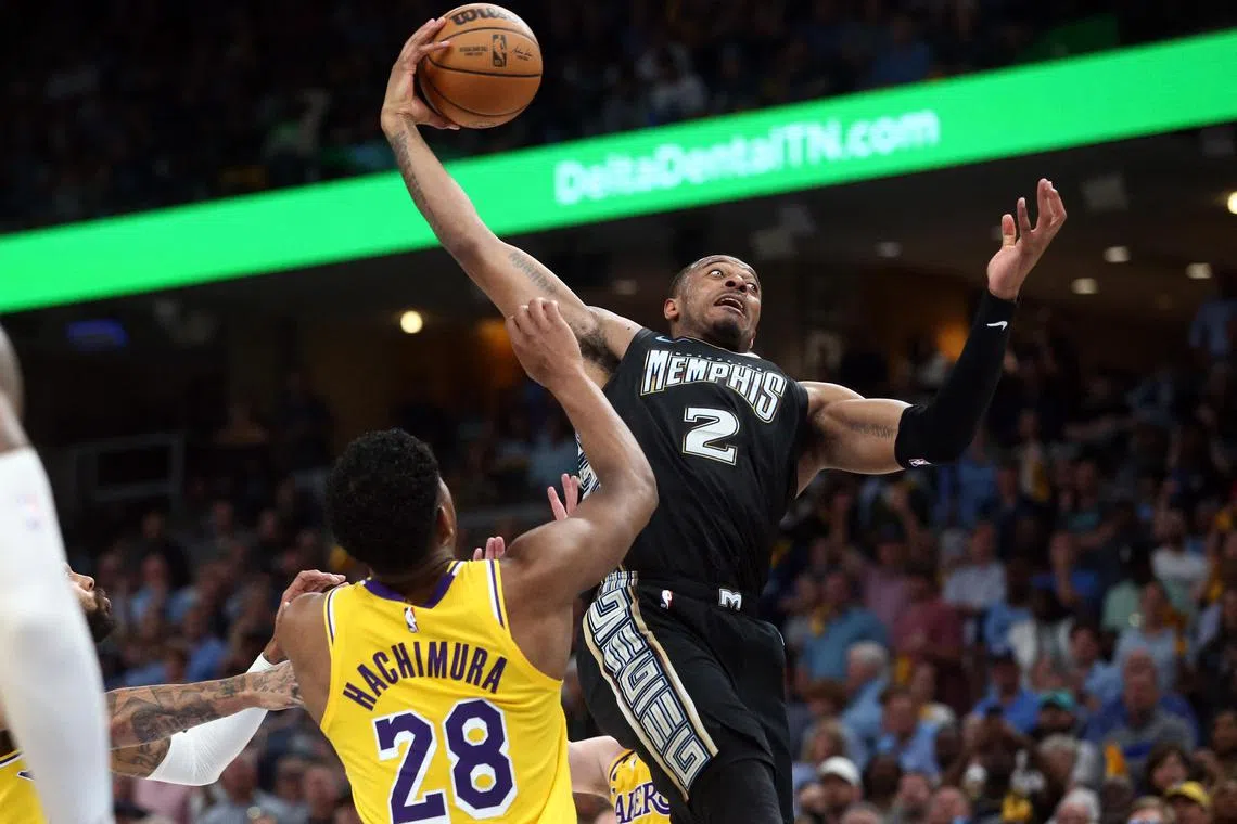 Apr 19, 2023; Memphis, Tennessee, USA; Memphis Grizzlies forward Xavier Tillman (2) collects a rebound over Los Angeles Lakers forward Rui Hachimura (28) during the second half during game two of the 2023 NBA playoffs at FedExForum. Mandatory Credit: Petre Thomas-USA TODAY Sports