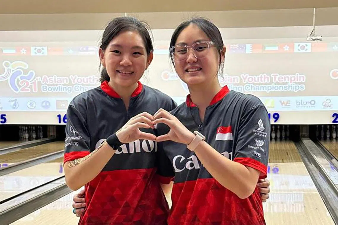 Singapore bowlers Ning Tay (left) and Colleen Pee posing after winning their girls' masters bronze and gold medals respectively at the Asian Youth Bowling Championships in Bangkok, Thailand.

PHOTO: SINGAPORE BOWLING FEDERATION