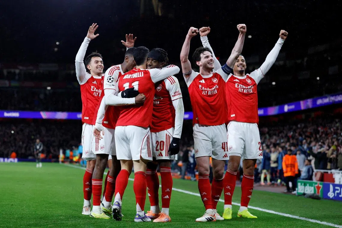 Arsenal's Gabriel Martinelli celebrates scoring their third goal with teammates. 