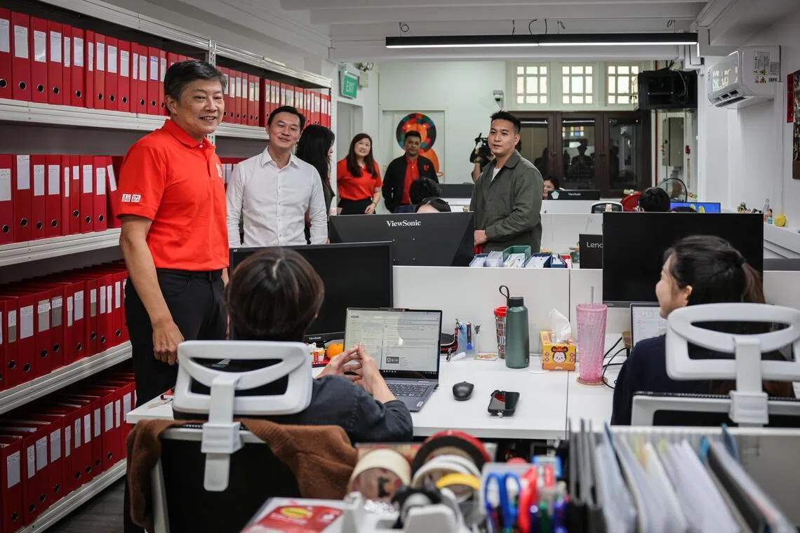 NTUC Secretary-General (SG) Ng Chee Meng (left) interacting with SIN Assurance PAC workers during a visit to the SIN Assurance PAC office on Feb 9, 2026.