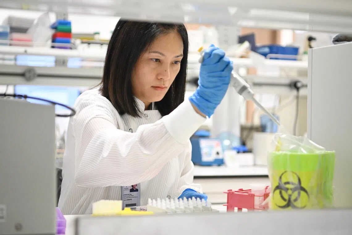 Dr Goh Liuh Ling, laboratory director and senior principal scientific officer at Tan Tock Seng Hospital Centre for Precision and Genomic Medicine carrying out tests on a patient's genes to see how he would react to his medication

ST PHOTO: AZMI ATHNI