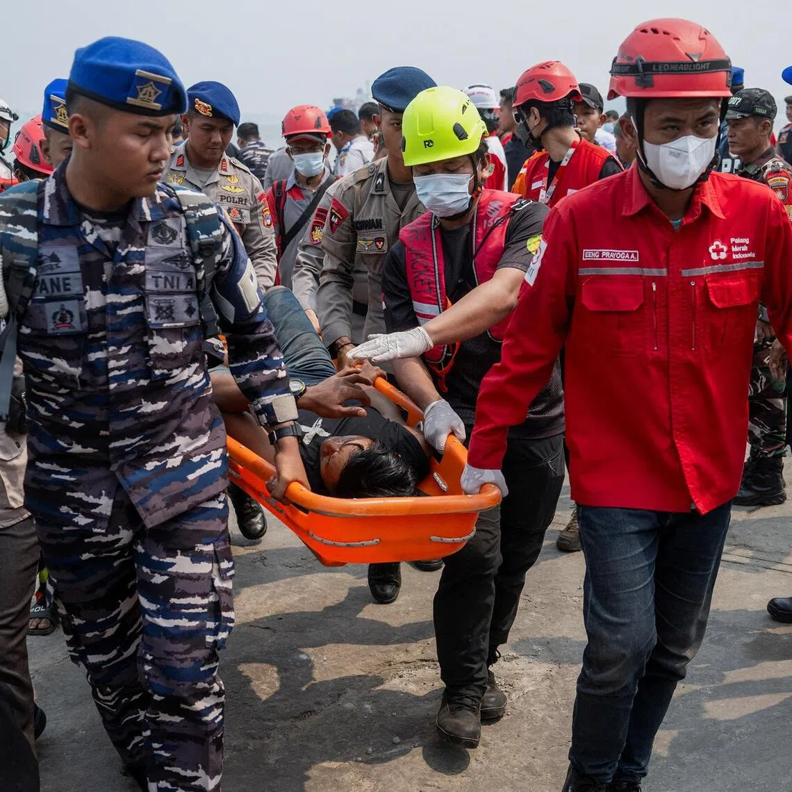 Rescuers carry a passenger of the Virgo Transport 8 ferry that capsized in Indonesia’s Java Sea on Sept 13.