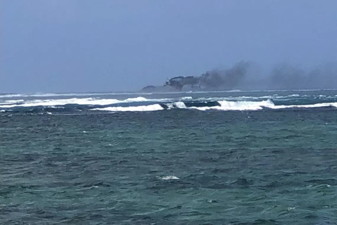 A view of a New Zealand Navy vessel on fire, as seen from Tafitoala, Samoa, Oct 6, in this picture obtained from social media.