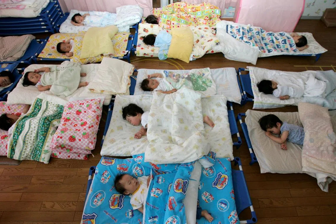 FILE PHOTO: Nursery school children take a nap at Hinagiku nursery in Moriyama, western Japan May 27, 2008. REUTERS/Yuriko Nakao/File Photo