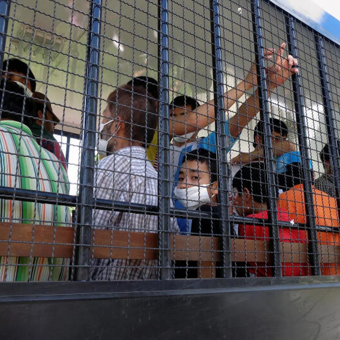 FILE PHOTO: Suspected Uyghurs are transported back to a detention facility in the town of Songkhla in southern Thailand after visiting women and children at a separate shelter March 26, 2014. Picture taken March 26, 2014. REUTERS/Andrew RC Marshall/File Photo