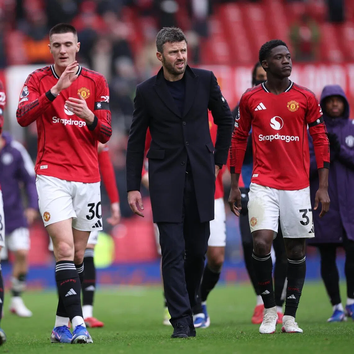 Manchester United interim manager Michael Carrick with his players after a 2-0 win over Tottenham Hotspur on Feb 7.