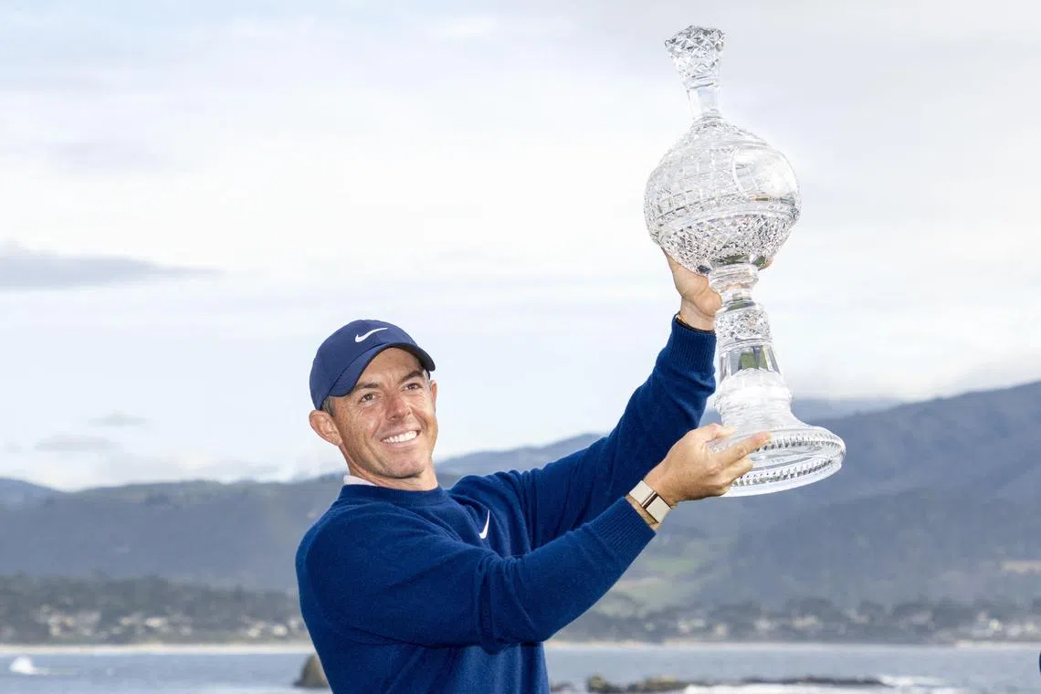 Rory McIlroy hoists the trophy during the final round of the Pebble Beach Pro-Am golf tournament.