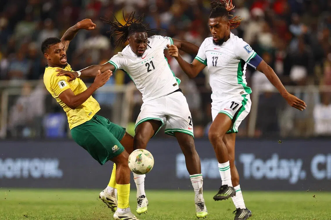 South Africa's Lyle Foster in action with Nigeria's Calvin Bassey and Alex Iwobi in their Africa World Cup Group C qualifier at Free State Stadium in Bloemfontein on Sept 9, 2025. Both the former finalists could miss out on automatic qualification, with Benin atop the group.