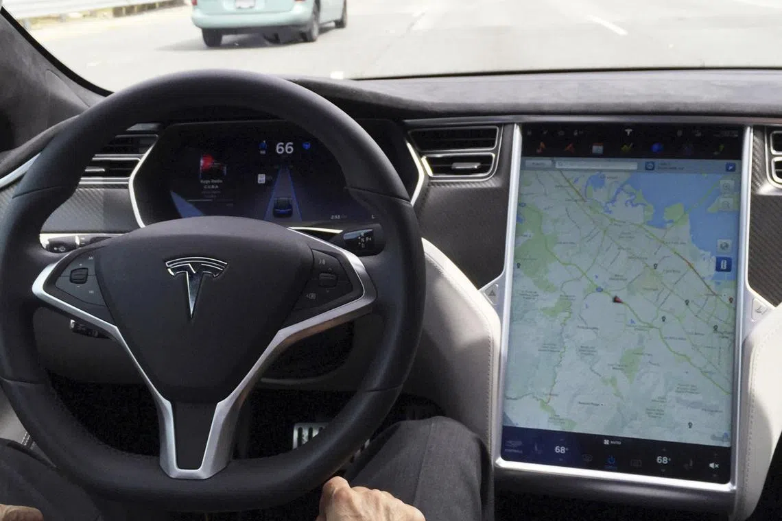 Not autonomous: A Tesla Model S driver taking his hands off the steering wheel as the car moves in so-called Autopilot mode in San Francisco on April 7, 2016.