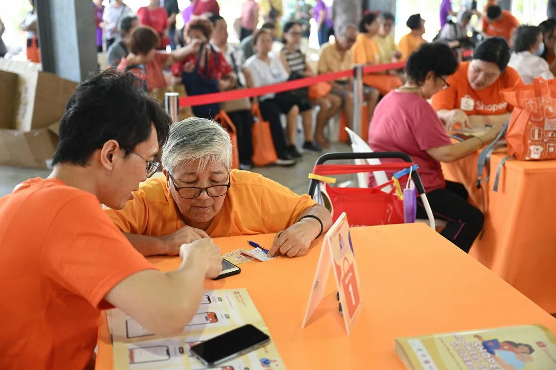 ST20240406_202428133598 zydigital06/ Zaihan Yusof/Azmi Athni//

Shopee staff Mr Ethan Weng (extreme left) teaching elderly guests how to use the Shopee app at Shopee Empowers Senior digital literacy event at Chong Pang 165 Hard Court on Apr 6

ST PHOTO: AZMI ATHNI