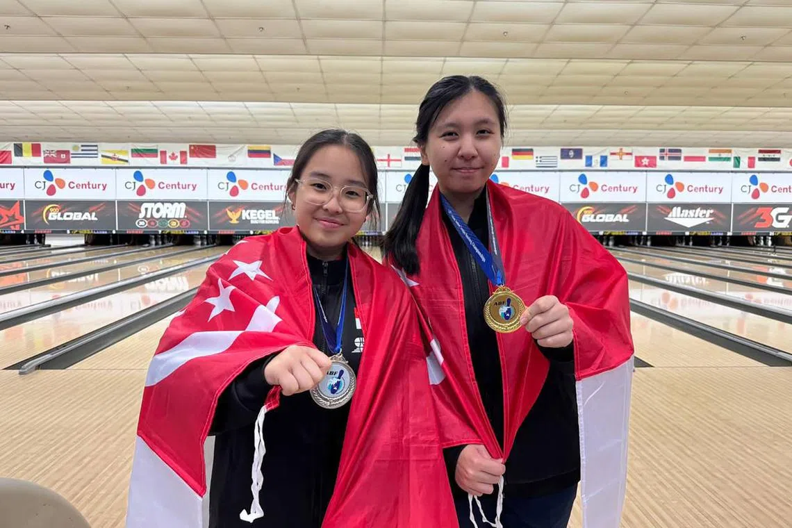 Ashley Lok (left) and Hazel Tan with their masters gold and silver medals at the Asian Junior Tenpin Bowling Championships in Petaling Jaya, Malaysia, on June 22.
