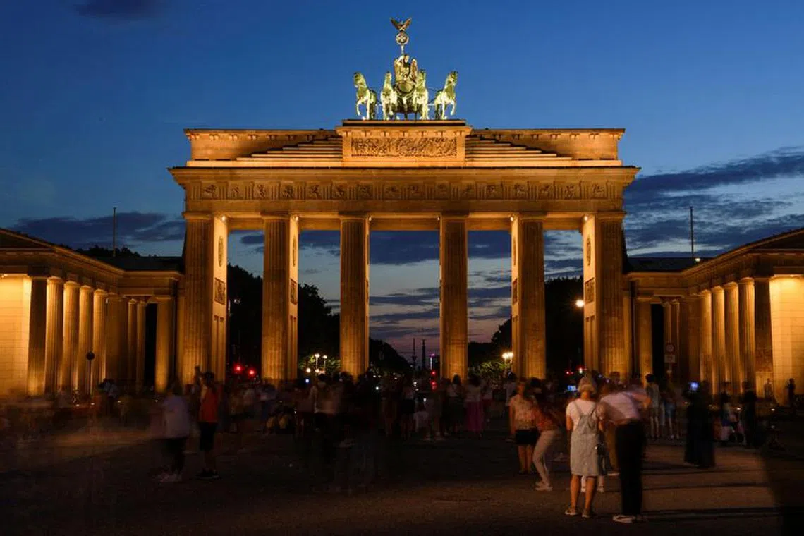 FILE PHOTO: A general view of the illuminated Brandenburg Gate is pictured during the night in Berlin, Germany. August 3, 2022. REUTERS/Annegret Hilse/File Photo