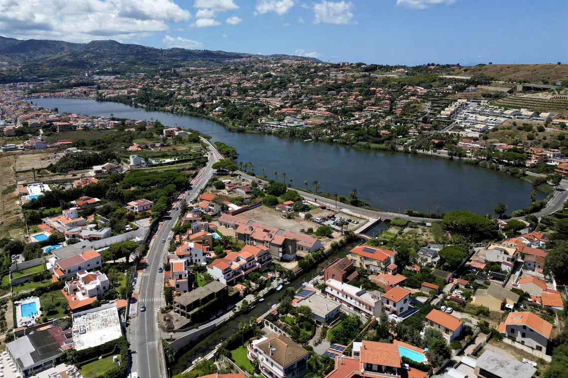 FILE PHOTO: A drone view shows Lake Ganzirri, part of the planned site for the construction of a suspension bridge along the Strait of Messina, connecting Sicily to mainland Italy, with construction expected to be completed by 2032, in Messina, Italy, August 5, 2025. REUTERS/Yara Nardi/File Photo