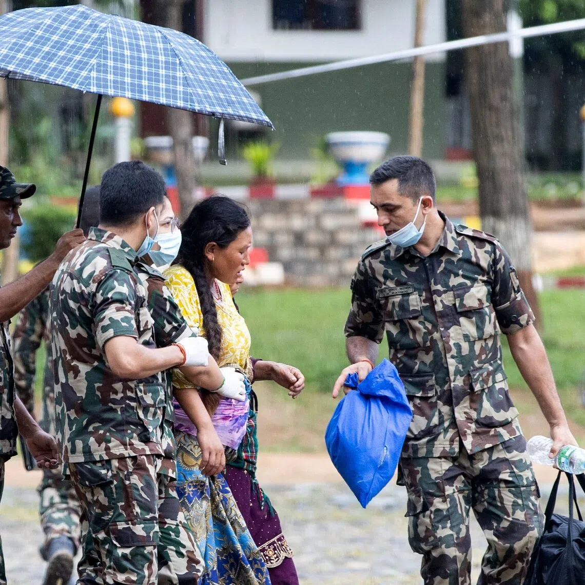Nepali military personnel evacuating a pregnant woman during rescue operations at Trishuli camp in Nepal’s Nuwakot district on Aug 28, 2026.