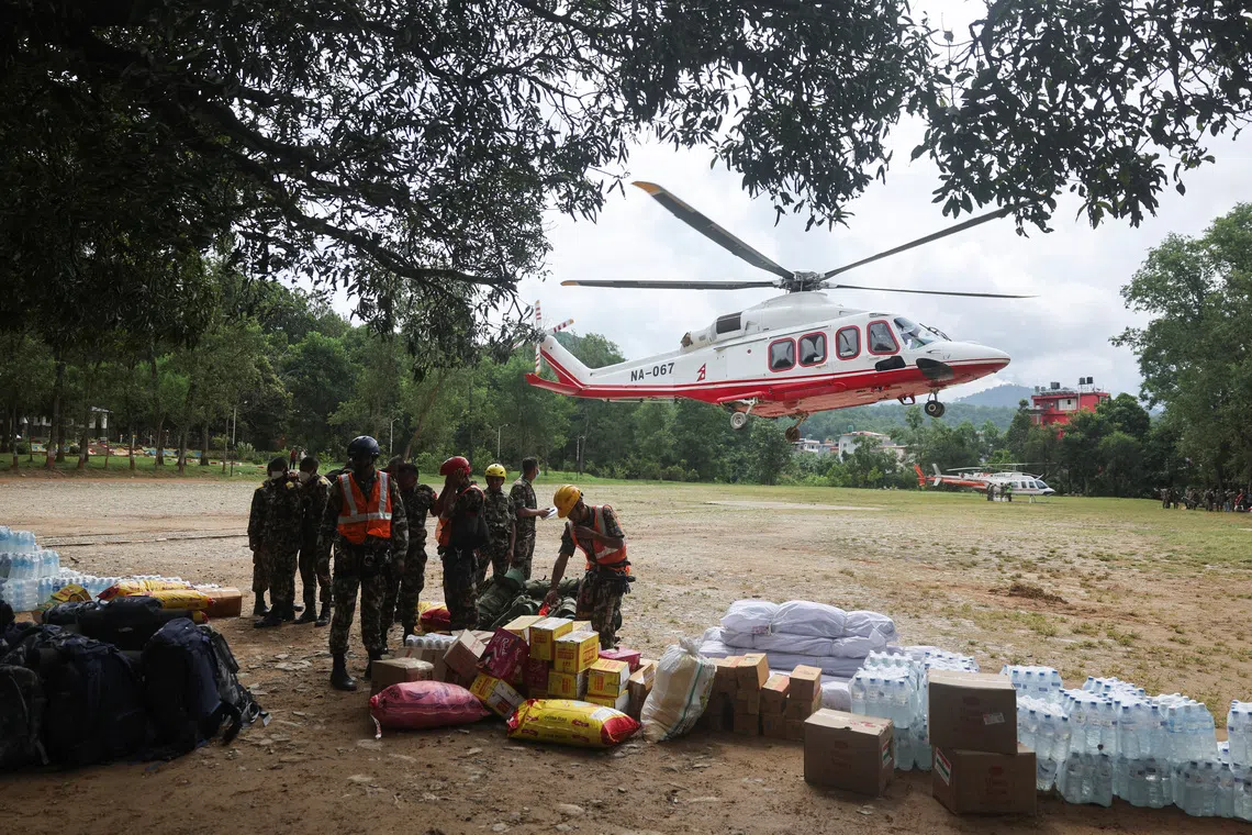 Army rangers waiting to load relief materials onto a helicopter in Nepal’s Nuwakot district on Aug 31.