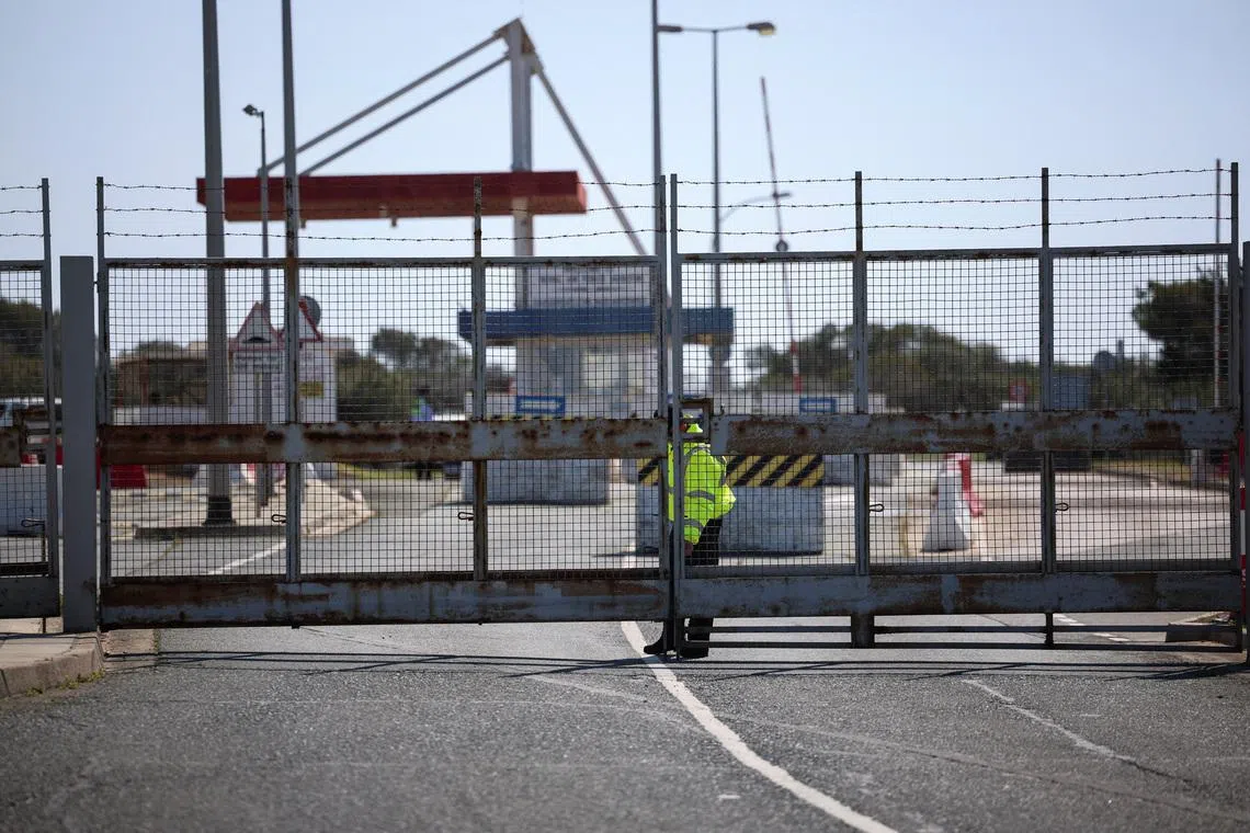 A police officer closes the entrance of RAF Akrotiri, a British sovereign base in Cyprus, which was hit by an unmanned drone overnight, causing limited damage, Cyprus March 2, 2026. REUTERS/Yiannis Kourtoglou