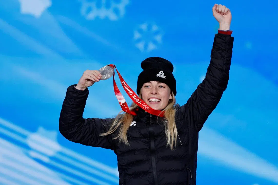 FILE PHOTO: 2022 Beijing Olympics - Victory Ceremony - Snowboard Women's Big Air - Beijing Medals Plaza, Beijing, China - February 15, 2022. Silver medallist, Zoi Sadowski Synnott of New Zealand celebrates on the podium. REUTERS/Tyrone Siu/File Photo