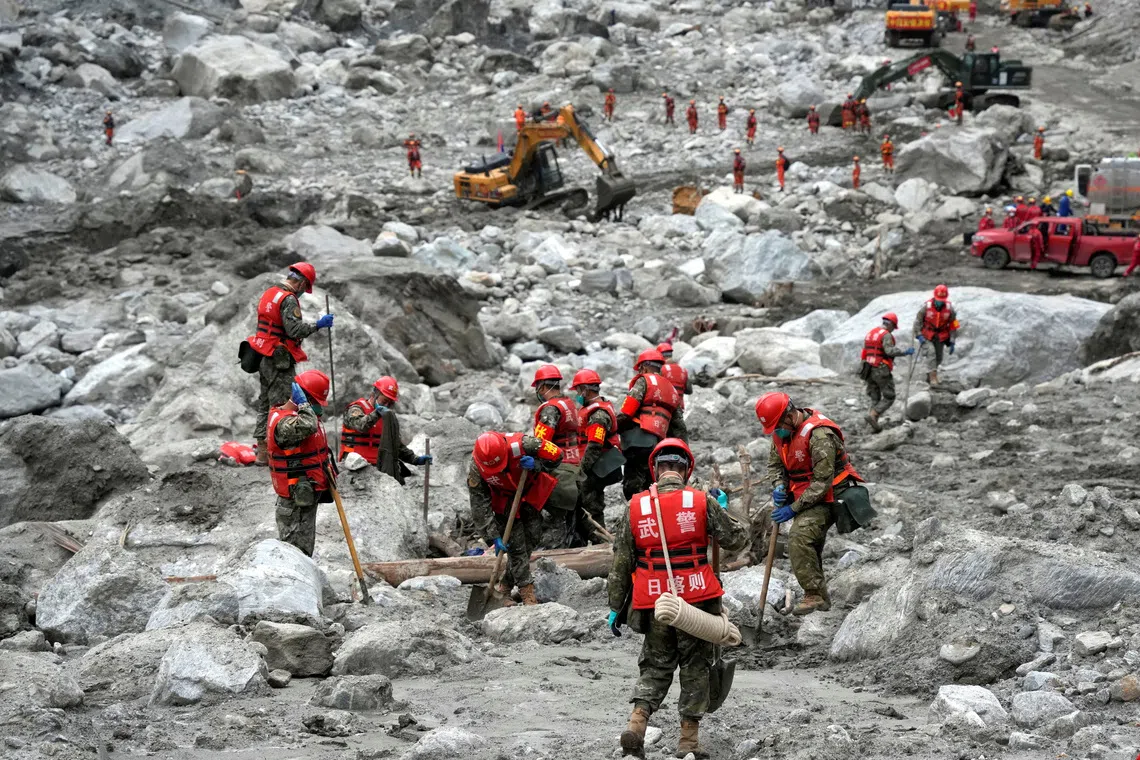 Rescue workers conduct search-and-rescue operations at the Gyirong border crossing separating China’s Tibet and Nepal.