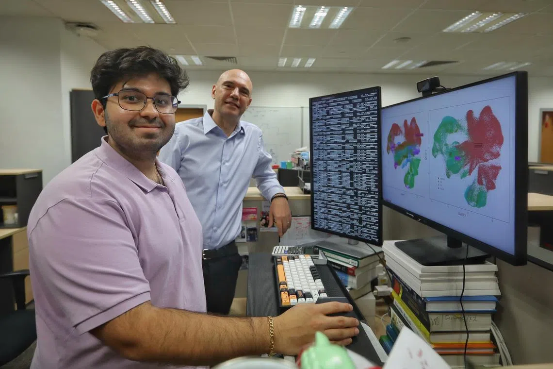 Duke-NUS Medical School student Kunal Mishra (left) and Associate Professor Jacques Behmoaras beside an advanced computer analysis of immune systems of patients with systemic sclerosis on May 23.