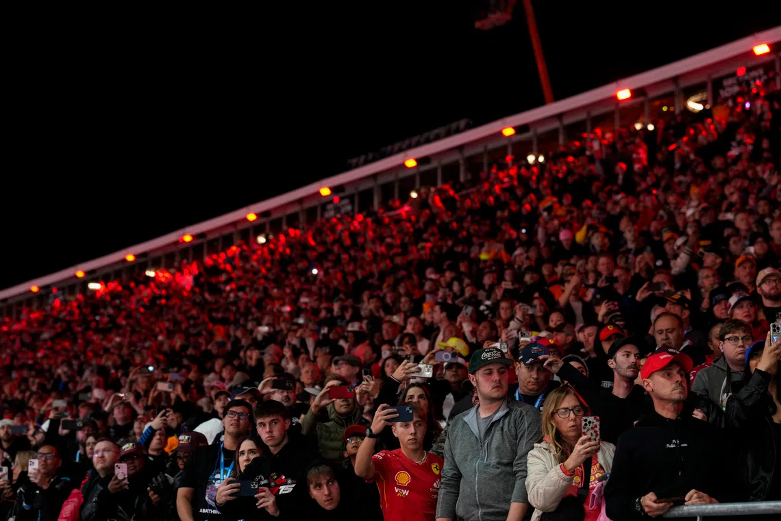 Nov 22, 2025; Las Vegas, NV, USA; Fans watch from the stands during the Las Vegas Grand Prix at the Las Vegas Strip Circuit. Mandatory Credit: Lucas Peltier-Imagn Images