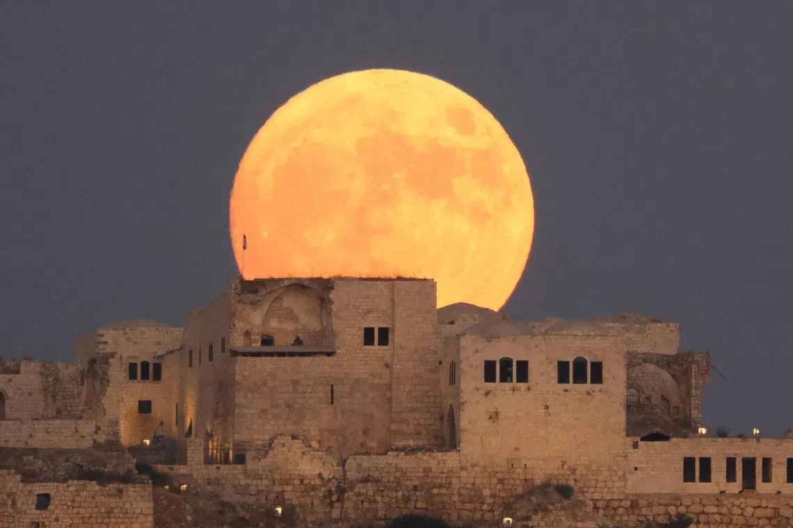 A blue supermoon rising above the ancient fortress in Migdal Tsedek National Park near Rosh Haayin, Israel, on Aug 30, 2023. 