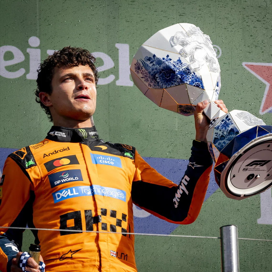 First placed McLaren driver Lando Norris of Britain poses with the trophy on the podium after the Formula 1 Dutch Grand Prix at the Circuit Zandvoort racetrack in Zandvoort, Netherlands.