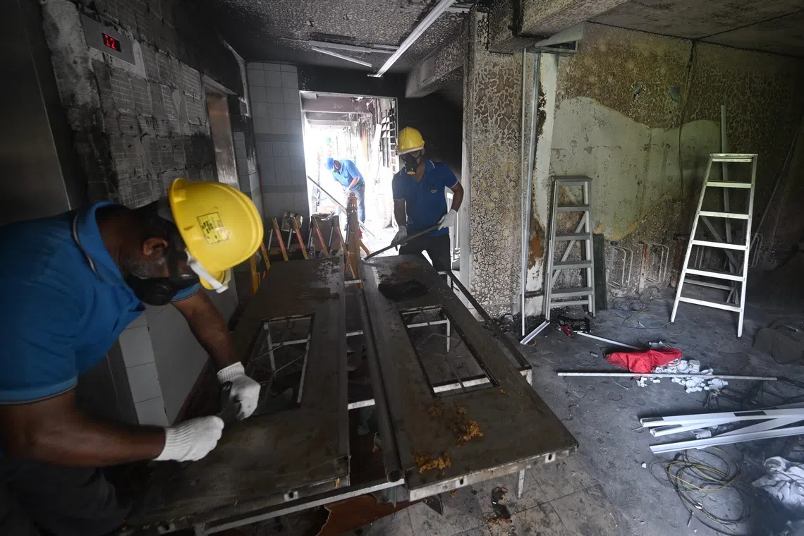 Workers doing repair works after the fire at 510 Ang Mo Kio Avenue 8, seen on Sept 26.