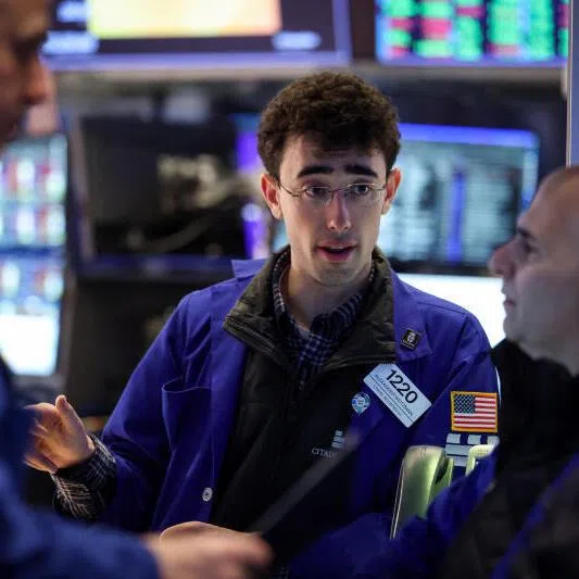 Traders work on the floor at the New York Stock Exchange in New York City, on Jan 26, 2026.