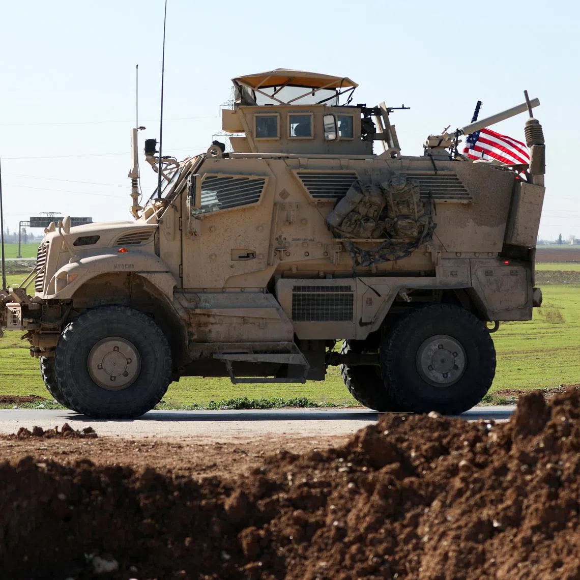 An armoured U.S. military vehicle moves towards the Iraqi Kurdistan region as U.S. troops withdraw from Qasrak military base in northeastern Syria, in Qamishli, Syria, February 23, 2026. REUTERS/Orhan Qereman