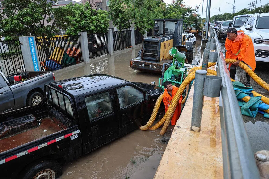 Workers pumping water from a flooded area following heavy rains caused by Typhoon Haikui in Xiamen, Fujian province, on Sept 6.
