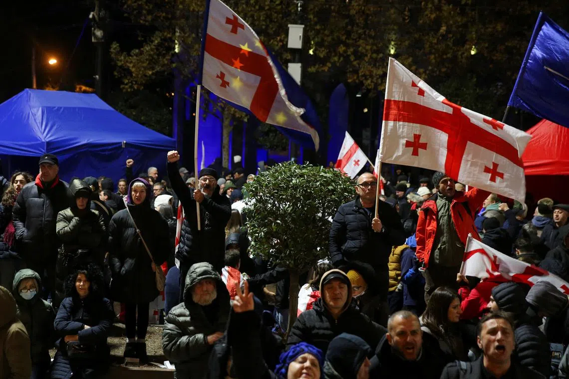 FILE PHOTO: Supporters of Georgia's opposition parties hold a rally to protest against the results of a parliamentary election, which the opposition say were rigged, on the eve of the new parliament's first session in Tbilisi, Georgia November 24, 2024. REUTERS/Irakli Gedenidze/File Photo
