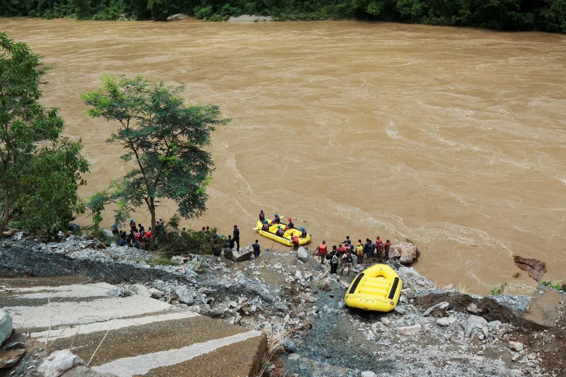 Members of rescue team search for the passenger buses that fell into the Trishuli River after the landslide at Simaltal area in Chitwan district, Nepal July 12, 2024. REUTERS/Stringer/File Photo
