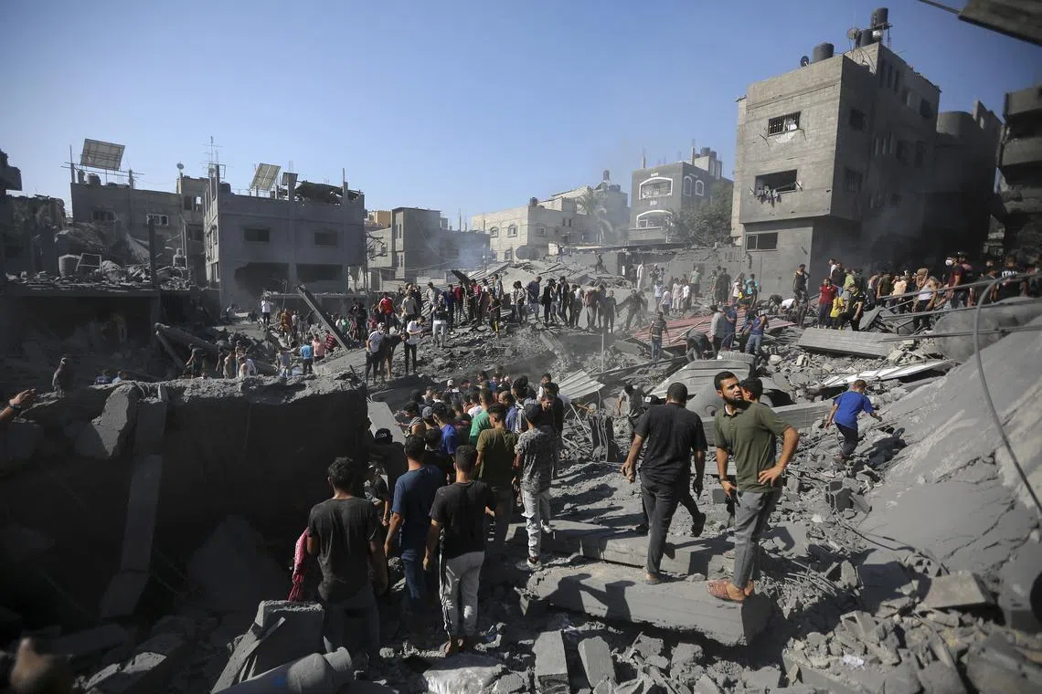 Palestinians inspecting destroyed homes in Khan Younis, in the southern Gaza Strip on Oct 26, 2023.