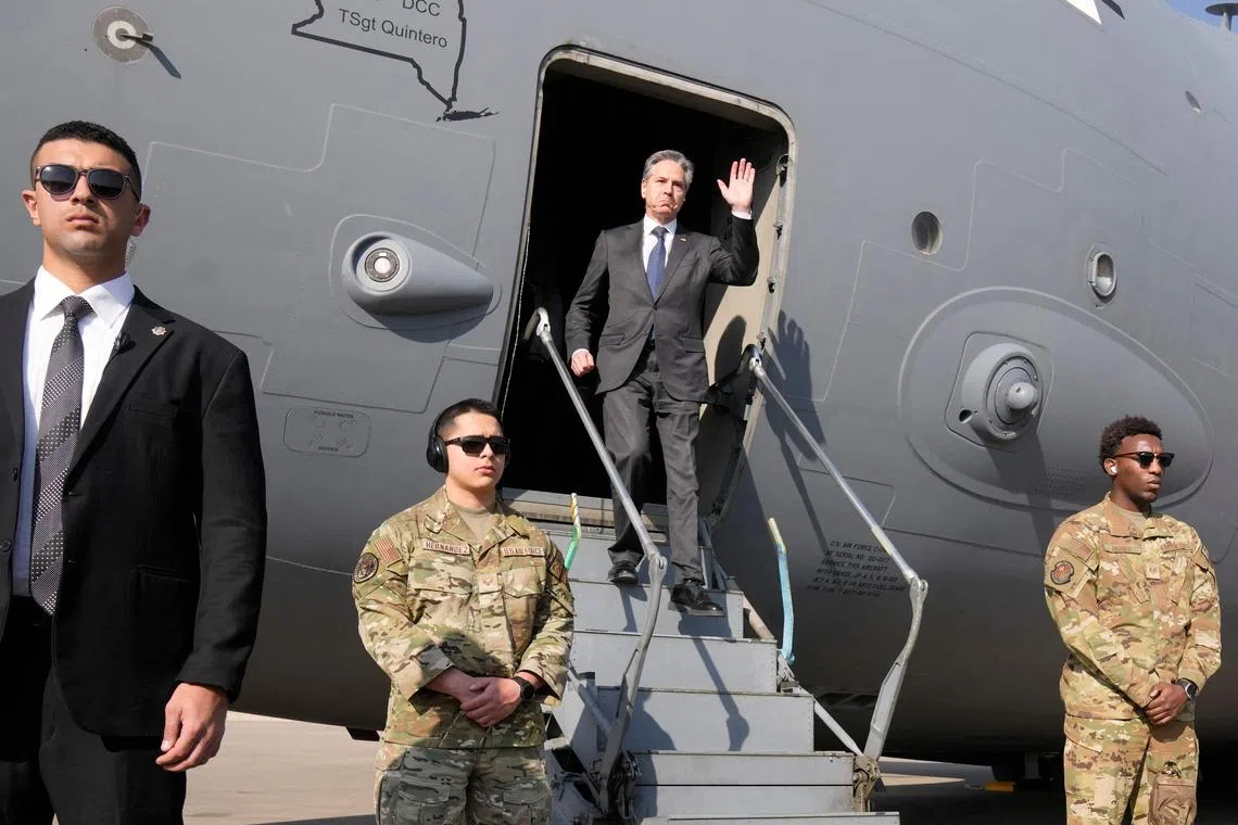 US Secretary of State Antony Blinken waves as he disembarks upon arrival at Cairo East Airport in Cairo.