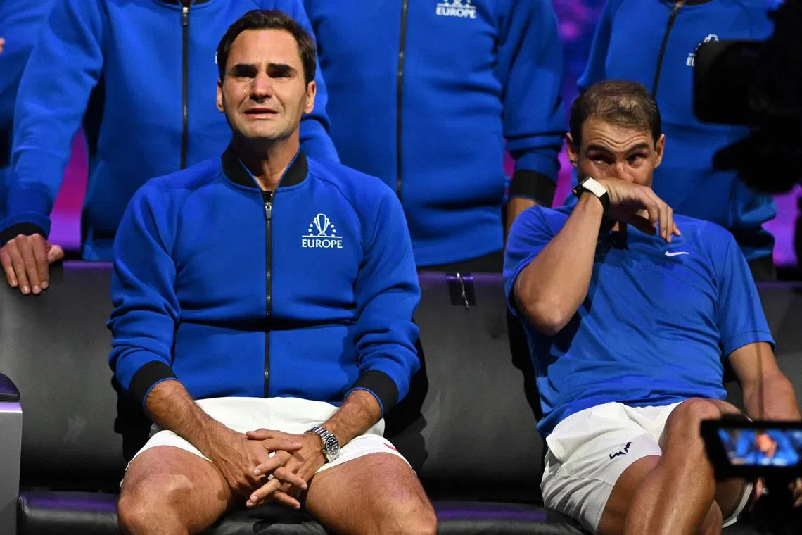 (FILES) In this file photo taken on September 24, 2022 Switzerland's Roger Federer (L) sheds a tear after playing his final match, a doubles with Spain's Rafael Nadal (R) of Team Europe against USA's Jack Sock and USA's Frances Tiafoe of Team World in the 2022 Laver Cup at the O2 Arena in London. - Tennis said goodbye to two of its greatest stars. Roger Federer, unable to shake off a lingering knee injury, called it quits at the age of 41 in September after a career which yielded 20 Grand Slams - a figure now passed by Rafael Nadal and Novak Djokovic. Federer collected 103 titles in his career and banked $130 million in prize money. (Photo by Glyn KIRK / AFP) / RESTRICTED TO EDITORIAL USE