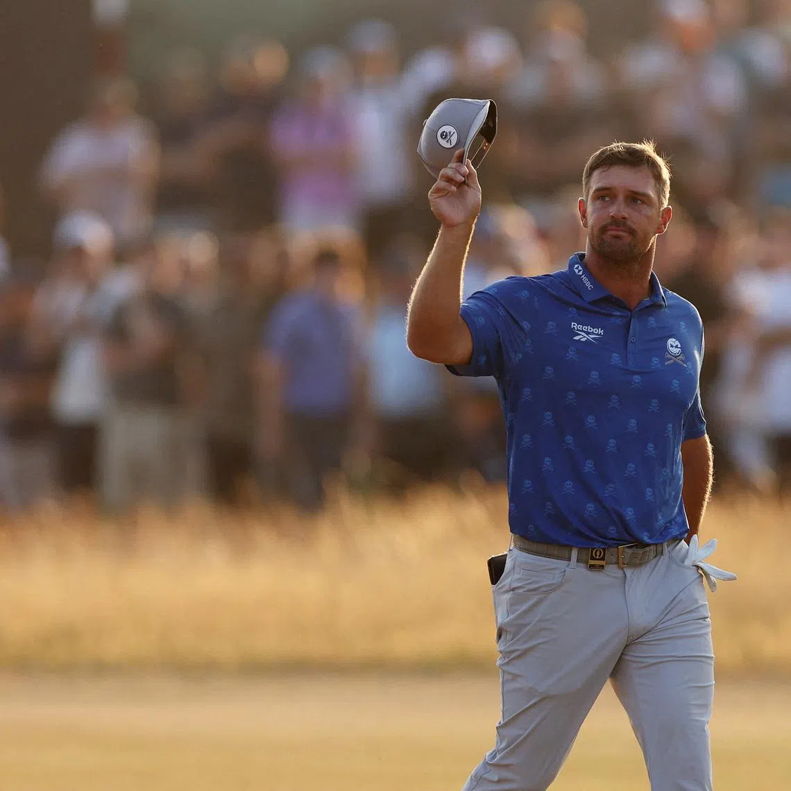 Golf - The 154th Open Championship - Royal Birkdale Golf Club, Southport, Britain - July 17, 2026  Bryson DeChambeau of the U.S. acknowledges fans on the 18th green during the second round REUTERS/Russell Cheyne     TPX IMAGES OF THE DAY