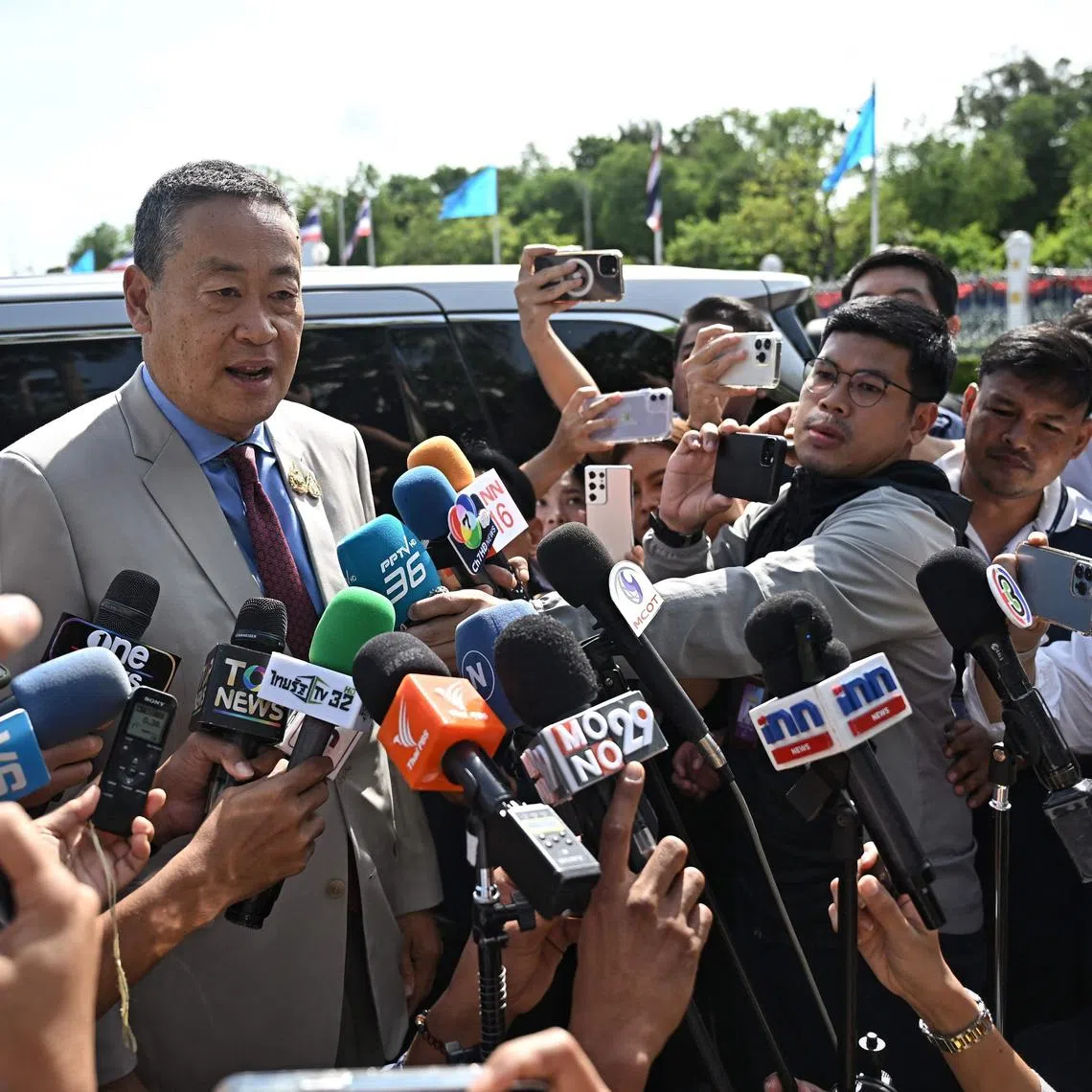 Thai prime minister Srettha Thavisin speaks to the media as he arrives at Government House, on the day the Constitutional Court rules on whether to remove him from office due to his appointment of a cabinet minister with a criminal conviction, in Bangkok on August 14, 2024. (Photo by Lillian SUWANRUMPHA / AFP)