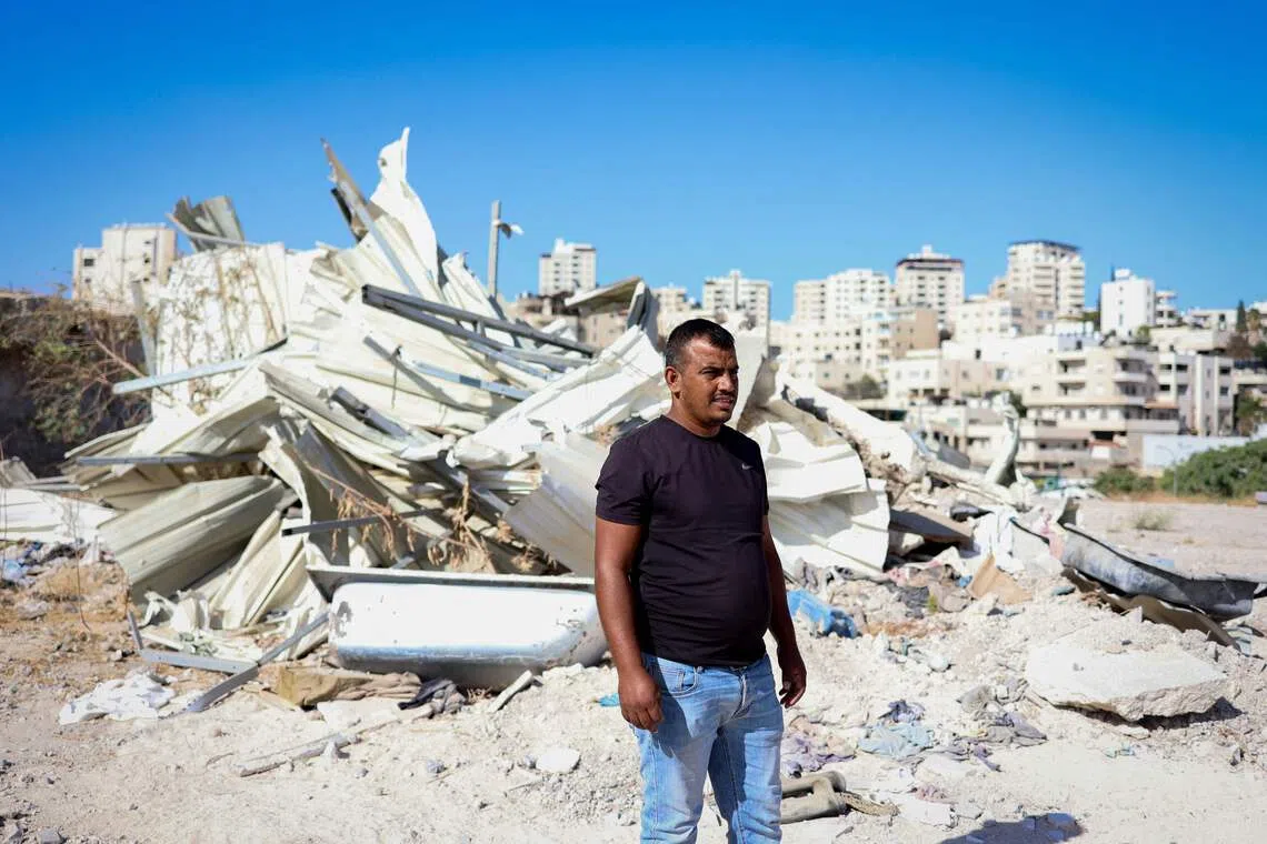 Palestinian Yahya Abu Ghaliyeh in front of his demolished home in Al-Eizariya town near Jerusalem on Sept 30.