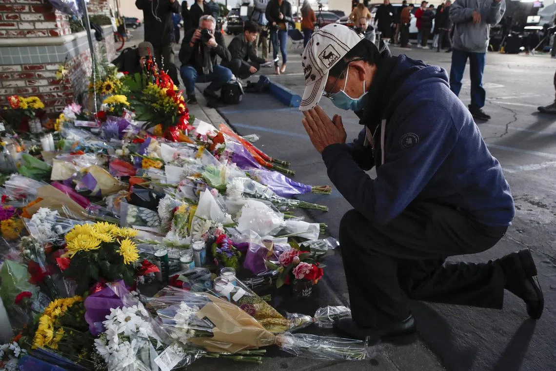 A person visits a makeshift memorial outside of Star Dance Studio in Monterey Park, California, U.S. on Jan 23,  2023. 