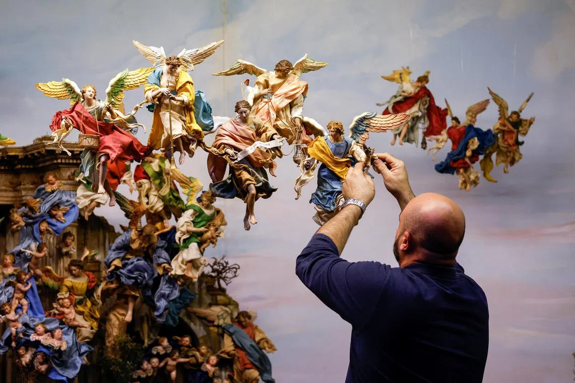 Crib enthusiast Omar Camilleri arranges figurines of angels on a Neapolitan crib, which spans some five meters (16 feet) and includes several figurines which date back to the 18th century, as part of the Christmas preparations at St Paul's Metropolitan Cathedral in Mdina, Malta November 29, 2022. 


