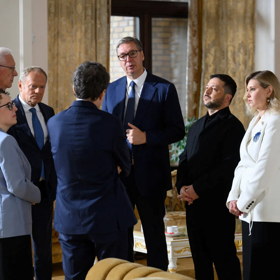 Ukraine's President Volodymyr Zelenskiy, Ukrainian first lady Olena Zelenska, Serbian President Aleksandar Vucic, Polish Prime Minister Donald Tusk, Czech politician Jiri Drahos, Austrian politician Christine Schwarz-Fuchs and Romanian President Nicusor Dan talk during the first time Carpathian Eight Summit, amid Russia's attack on Ukraine, in Ivano-Frankivsk region, Ukraine, September 18, 2026. Ukrainian Presidential Press Service/Handout via REUTERS ATTENTION EDITORS - THIS IMAGE HAS BEEN SUPPLIED BY A THIRD PARTY.