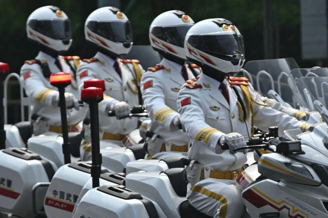 A police escort group on motorbikes driving ahead of US President Donald Trump's motorcade in Beijing on May 14.