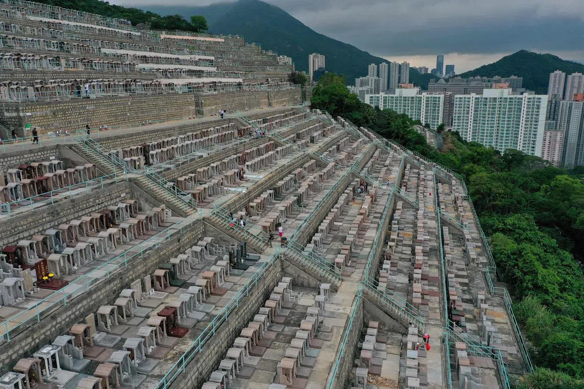 Families attending graves at the Chai Wan Chinese Cemetery in Hong Kong on April 4, 2024, as people visit cemeteries to honour their ancestors during the annual Tomb Sweeping Day, known locally in Hong Kong as Qing Ming Festival. 