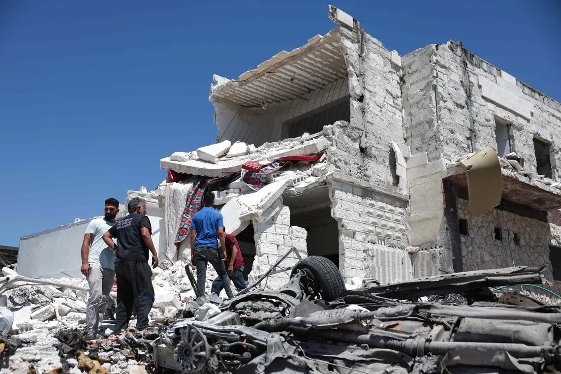People inspect the rubble of a house following reported Russian airstrikes on the north-west Syrian city of Idlib.
