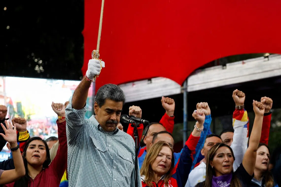 Venezuelan President Nicolas Maduro holds up a replica of independence hero Simon Bolivar's sword during a rally to celebrate the results of last month's presidential election, in Caracas, Venezuela August 28, 2024. REUTERS/Fausto Torrealba/File Photo