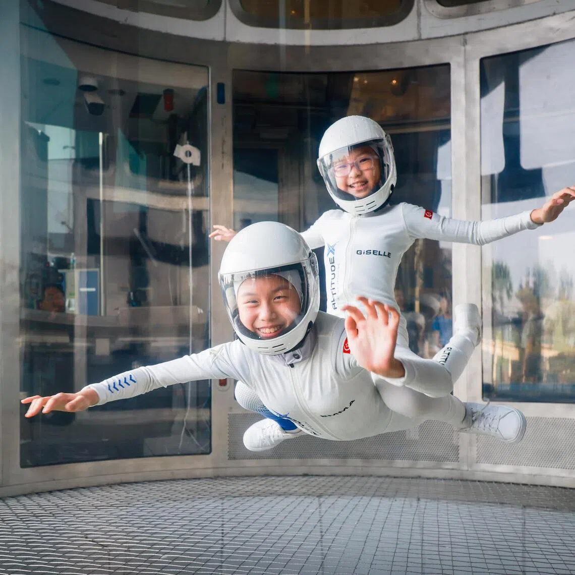 10-year-old indoor skydivers Emma Koh (bottom) and Giselle Lee have been best friends since birth.